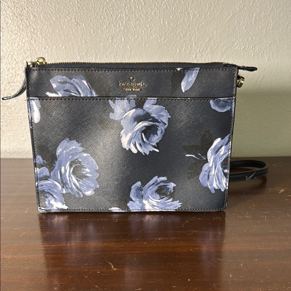Kate Spade Night Rose Crossbody Bag has front pocket with magnetic closure.